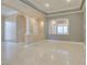 Spacious living room showcasing marble floors, architectural columns, and open access to other rooms at 10260 Hawks Wing St, Las Vegas, NV 89178