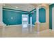 Bright living room enhanced by columns and a chandelier, flowing into other living spaces at 10260 Hawks Wing St, Las Vegas, NV 89178