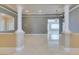 Elegant living space featuring stately columns, marble flooring, and neutral color palette at 10260 Hawks Wing St, Las Vegas, NV 89178