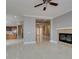 Spacious living room with marble floors, fireplace, and an open floor plan flowing into the kitchen at 10260 Hawks Wing St, Las Vegas, NV 89178