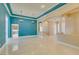 Bright living room with travertine floors leading to open kitchen space at 10260 Hawks Wing St, Las Vegas, NV 89178
