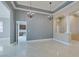 Bright living room with marble flooring, elegant chandeliers, and seamless flow into other spaces at 10260 Hawks Wing St, Las Vegas, NV 89178