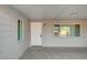 Covered entryway with neutral siding, a white front door, and views of the neighborhood at 105 Ash St, Henderson, NV 89015