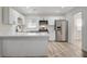 Stylish kitchen with white cabinetry, stainless steel appliances, and quartz countertops, perfect for cooking at 105 Ash St, Henderson, NV 89015