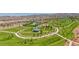 A beautiful aerial view of the community park with walking paths and a pool for residents to enjoy at 122 Cabaletta Ln, Henderson, NV 89015