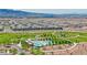 Stunning aerial view of the neighborhood, showcasing a pool, gazebo and manicured green spaces at 122 Cabaletta Ln, Henderson, NV 89015