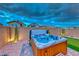 Inviting backyard with a luxurious hot tub, mini-golf area, and desert plants at 122 Cabaletta Ln, Henderson, NV 89015