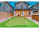 Picturesque backyard featuring a mini-golf area, spa, and covered patio at 122 Cabaletta Ln, Henderson, NV 89015