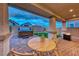 Charming backyard patio with hot tub, mini-golf, and a cozy outdoor table with chairs at 122 Cabaletta Ln, Henderson, NV 89015