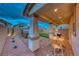 Relaxing covered patio area with a hot tub, putting green, and outdoor seating at 122 Cabaletta Ln, Henderson, NV 89015