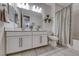 Bright bathroom with double sinks, a large mirror, and a bathtub with a shower curtain at 122 Cabaletta Ln, Henderson, NV 89015