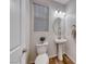 Compact bathroom with a pedestal sink, toilet, and neutral decor at 122 Cabaletta Ln, Henderson, NV 89015