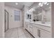 Bright bathroom with dual sinks, ample lighting, and tile flooring at 122 Cabaletta Ln, Henderson, NV 89015