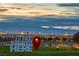 Panoramic view of the Las Vegas skyline at sunset with the community sign 