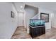 Inviting entryway features wood-look flooring, an aquarium, and a staircase leading upstairs at 122 Cabaletta Ln, Henderson, NV 89015