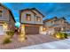 Inviting home with a two-car garage, attractive landscaping, and a welcoming entrance at 122 Cabaletta Ln, Henderson, NV 89015