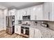 Well-equipped kitchen with stainless steel appliances, granite countertops, and modern cabinetry at 122 Cabaletta Ln, Henderson, NV 89015