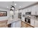 Modern kitchen with stainless steel appliances, granite countertops, and a kitchen island with barstools at 122 Cabaletta Ln, Henderson, NV 89015