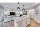 Open concept kitchen and living room with a large kitchen island and comfortable living space at 122 Cabaletta Ln, Henderson, NV 89015