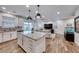 Open floor plan with island kitchen, wood floors, and seamless flow to the living area at 122 Cabaletta Ln, Henderson, NV 89015