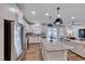 Open concept kitchen and living room with stainless appliances, large island and comfortable couch at 122 Cabaletta Ln, Henderson, NV 89015