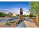 View of a neighborhood entrance with a brick sign and manicured landscaping at 122 Cabaletta Ln, Henderson, NV 89015