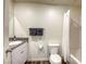 Cozy bathroom featuring a granite vanity top, a toilet, and a shower behind a curtain at 12728 Feathersong St, Henderson, NV 89044