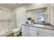 Modern bathroom with granite countertops, white cabinetry, and a glass-enclosed shower at 12728 Feathersong St, Henderson, NV 89044