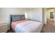 Nicely staged bedroom featuring a plush bed with pillows and a nightstand at 12728 Feathersong St, Henderson, NV 89044