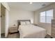 Inviting bedroom with a large window, plush bedding, and neutral tones at 12728 Feathersong St, Henderson, NV 89044