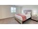 Comfortable bedroom with a queen bed, soft pink accents, and a window providing natural light at 12728 Feathersong St, Henderson, NV 89044