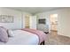 Comfortable bedroom with a queen bed, soft pink accents, and a dresser in the background at 12728 Feathersong St, Henderson, NV 89044