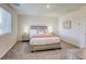 Comfortable bedroom with a queen bed, soft pink accents, and a window providing natural light at 12728 Feathersong St, Henderson, NV 89044