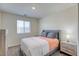 Cozy bedroom with window, a bed with decorative pillows and a lamp on a nightstand at 12728 Feathersong St, Henderson, NV 89044