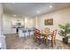 Open dining area features wood-look floors, modern island seating, and white cabinets at 12728 Feathersong St, Henderson, NV 89044