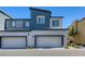 Modern two-story home featuring dual garage doors and contemporary architecture at 12728 Feathersong St, Henderson, NV 89044