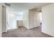 Upstairs hallway with carpet flooring and doors leading to various rooms at 12728 Feathersong St, Henderson, NV 89044