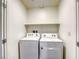 A laundry room featuring a white washer, a white dryer, and a shelf above the machines at 12728 Feathersong St, Henderson, NV 89044