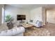 Living room with wood-look floors, a tufted couch, and decorative throw blanket at 12728 Feathersong St, Henderson, NV 89044