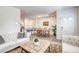 Bright living room with wood-look floors flows into open kitchen and dining area at 12728 Feathersong St, Henderson, NV 89044