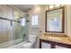 Bathroom featuring a shower-tub combo with glass door and granite topped vanity, creating a practical space at 2007 Trailside Village Ave, Henderson, NV 89012