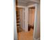 View of the closet and bathroom with neutral colored tile and a shower with curtain at 220 Flamingo Rd # 210, Las Vegas, NV 89169