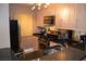Bright kitchen with stainless steel appliances, granite countertops, and light wood cabinets at 220 Flamingo Rd # 210, Las Vegas, NV 89169