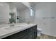 Modern bathroom featuring a double sink vanity with quartz countertop and wood-look flooring at 221 Mountain Cedar Ct, North Las Vegas, NV 89031