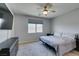 This bedroom has soft carpet, a ceiling fan, and modern furniture, offering both comfort and style at 221 Mountain Cedar Ct, North Las Vegas, NV 89031