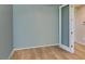 Bright bedroom features neutral paint, wood-look flooring, and white door at 221 Mountain Cedar Ct, North Las Vegas, NV 89031