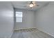 Neutral bedroom with gray carpet, ceiling fan, and a window allowing natural light at 221 Mountain Cedar Ct, North Las Vegas, NV 89031