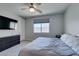 Cozy bedroom with carpet, ceiling fan, window, and TV, perfect for relaxation and entertainment at 221 Mountain Cedar Ct, North Las Vegas, NV 89031