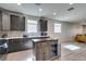 This kitchen features wooden cabinets, stainless steel appliances, a kitchen island, and modern recessed lighting at 221 Mountain Cedar Ct, North Las Vegas, NV 89031