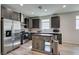Bright kitchen with stainless appliances, center island, and decorative backsplash at 221 Mountain Cedar Ct, North Las Vegas, NV 89031